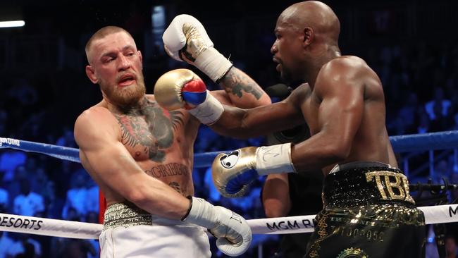 Floyd Mayweather Jr. throws a punch at Conor McGregor.