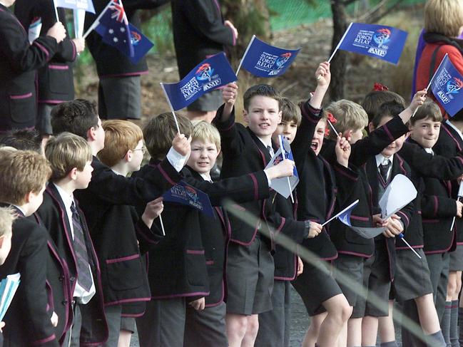 Sport Olympic Torch Relay Day 57, August 03, 2000: Children from the Hutchins School wave to the torch on its way from Mount. Nelson to Hobart central. Mount Nelson to Hobart. NEWS: