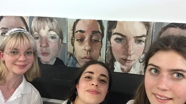 ARTEXPRESS: Ella Thomas, 18, Mackellar Girls Campus, Manly Vale, with friends in front of their self-portraits. Ella is centre.