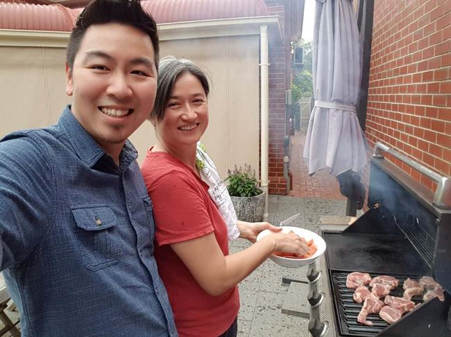 Penny Wong cooking a barbecue with her younger brother James Wong Kein Peng. Picture: Supplied