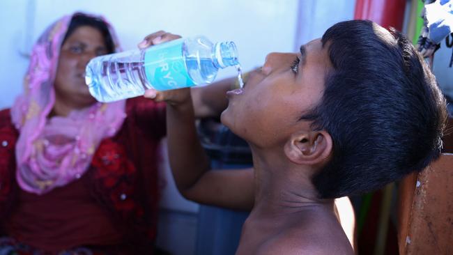 A young Rohingya refugee drinks on board a rescue vessel. Picture: AFP