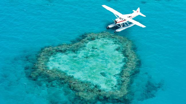 GSL Aviation's seaplane next to Heart Reef in the Whitsundays. Picture: GSL Aviation