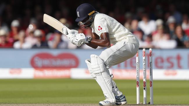 England fast bowler Jofra Archer ducks a bouncer from Pat Cummins. Picture: AP