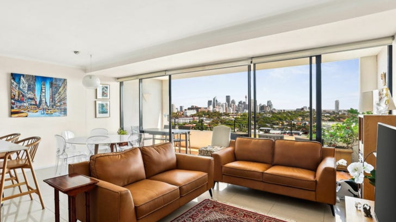 1814/780 Bourke St, Redfern has open-plan living areas leading to a balcony with city skyline views.