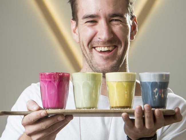 Jayben Newson, owner of Too Many Chiefs, shows off the rainbow coffees. Picture: Eugene Hyland