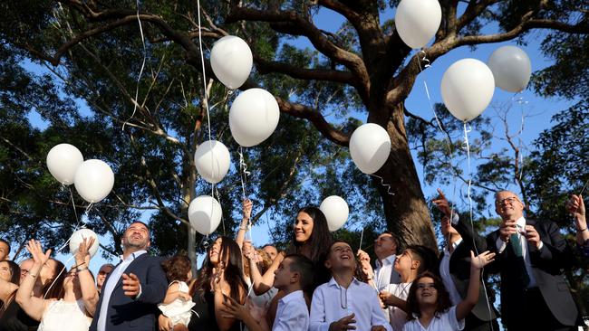 The Abdallah and Sakr families and guests release white balloons at the unveiling. Picture: Damian Shaw