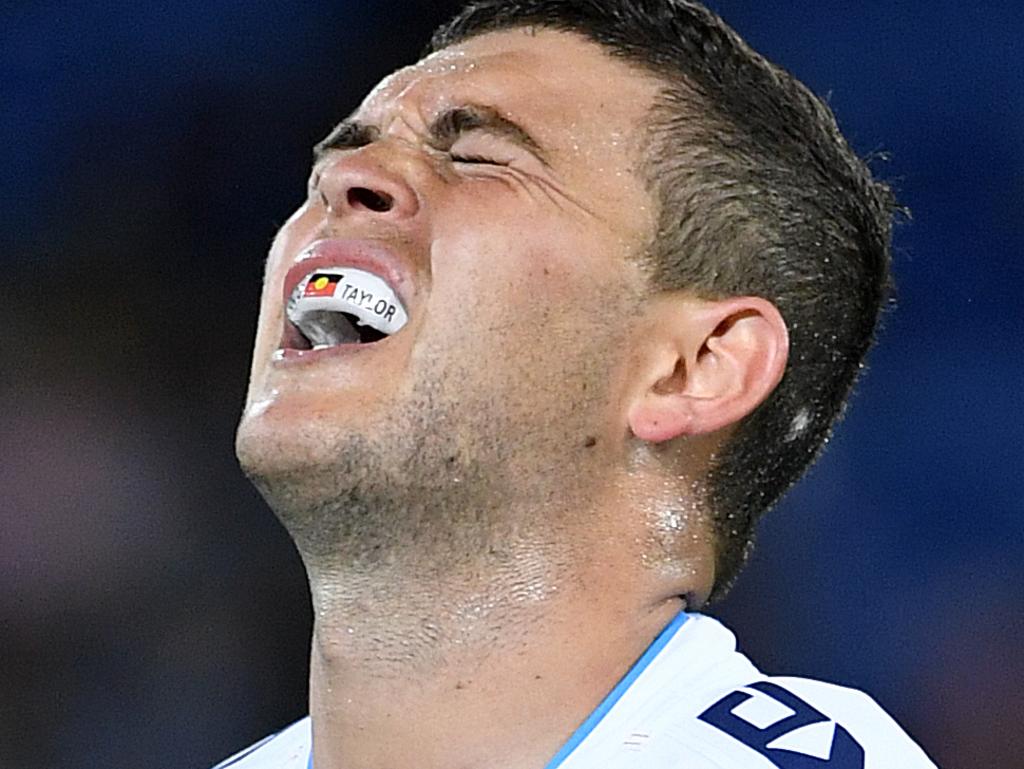 Ashley Taylor  of the Titans grimaces after sustaining an injury during the Round 5 NRL match between the Gold Coast Titans and the Penrith Panthers at CBUS Stadium on the Gold Coast, Friday, April 12, 2019. (AAP Image/Dave Hunt) NO ARCHIVING, EDITORIAL USE ONLY