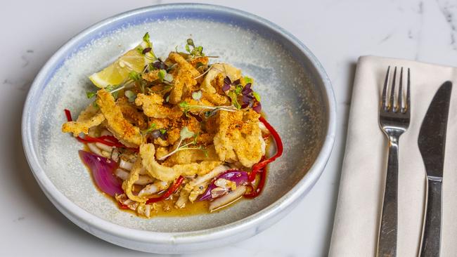 Franklin Wharf Restaurant &amp; Bar’s tender, flash-fried Korean squid is topped with a flurry of togarashi and served with black sesame and pickled red onion. Picture: RICHARD HO from MINCH MEDIA.