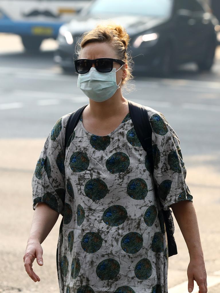 As smoke from bushfires engulfs Sydney, morning commuters are pictured wearing face masks as they make their way to work. Picture: MATRIX