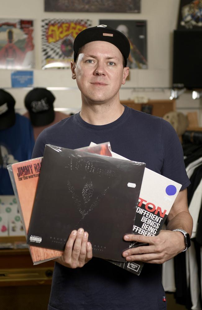 Hilltop Hoods member Suffa at Clarity Records in Adelaide with some of his favourite South Australian albums. Picture: Naomi Jellicoe