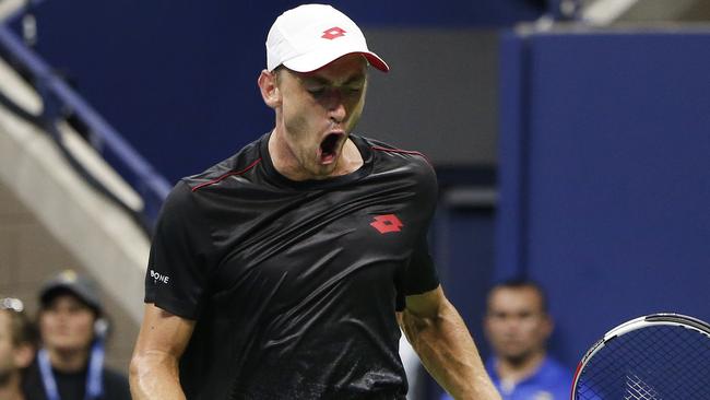 John Millman celebrates winning a point against Roger Federer on Tuesday. Picture: AP