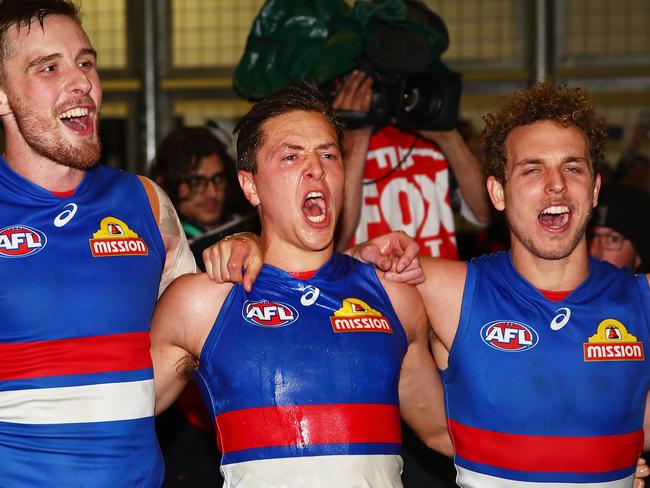 Fergus Greene (middle) celebrates a Bulldogs victory.