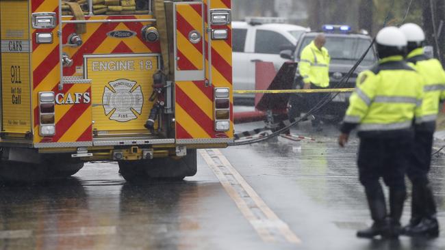 The tail of the  crashed helicopter is seen in the middle of the street in the Kailua neighbourhood. Picture: AP