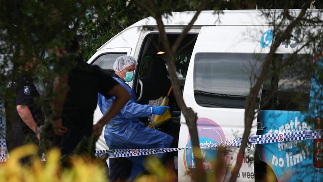 Police officers attend Hambledon State School at Edmonton, where “Meeky” was found dead in a Goodstart Early Learning Centre minibus. A police forensic officer inspects the van. PICTURE: BRENDAN RADKE