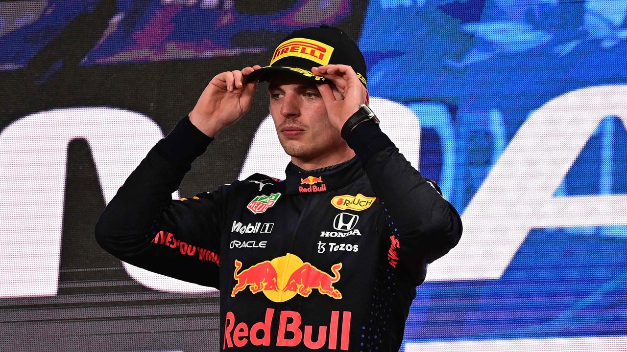 Red Bull's Dutch driver Max Verstappen stands on the podium following the Qatari Formula One Grand Prix at the Losail International Circuit, on the outskirts of the capital city of Doha, on November 21, 2021. (Photo by ANDREJ ISAKOVIC / AFP)