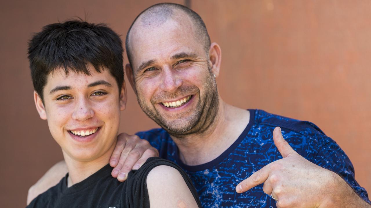 14-year-old Timothy Kist, pictured with his fully vaccinated dad Alexander Kist, received his second Covid-19 jab at Toowoomba State High School in Queensland Healths weekend vaccination blitz, Saturday, October 23, 2021. Picture: Kevin Farmer