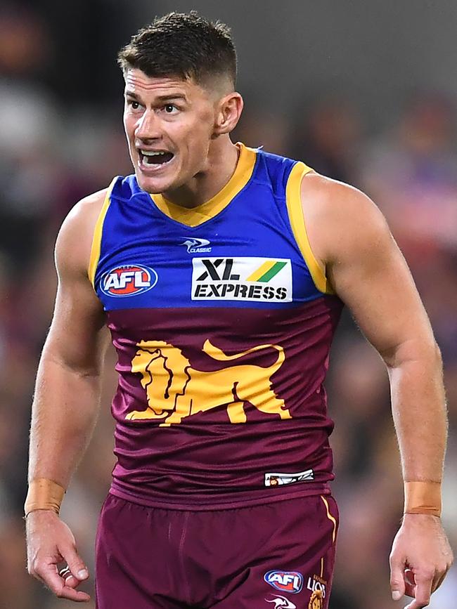 Dayne Zorko has a word with teammates.