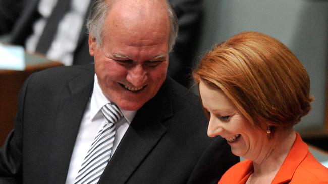 Prime Minister Julia Gillard speaks to independent MP Tony Windsor after question time at Parliament House (AAP Image/Alan Porritt)