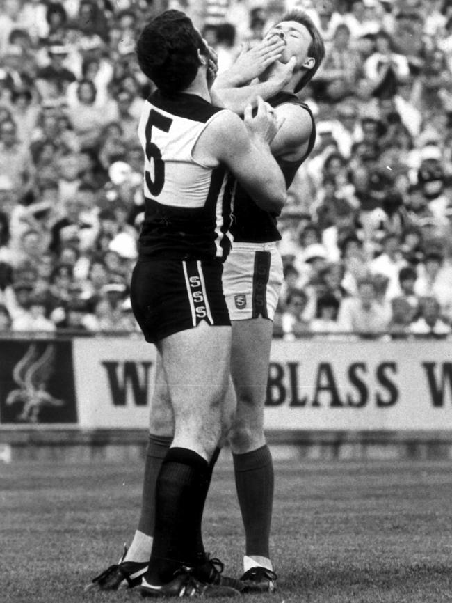 Port Adelaide’s Tim Evans (left) and Norwood’s Craig Balme come to blows in the 1984 grand final.