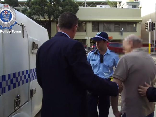 Strike force detectives arrest a man over historic Sydney bank robberies in December 2018.