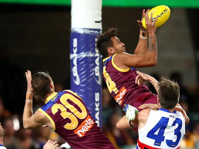 BRISBANE, AUSTRALIA - AUGUST 08: Callum Ah Chee of the Lions marks the ball during the round 11 AFL match between the Brisbane Lions and the Western Bulldogs at The Gabba on August 08, 2020 in Brisbane, Australia. (Photo by Jono Searle/AFL Photos/via Getty Images)