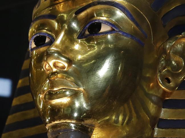 FILE - In this Saturday, Jan. 24, 2015, file photo, the gold mask of King Tutankhamun is seen in its glass case during a press tour, in the Egyptian Museum near Tahrir Square, Cairo, Egypt. Egypt’s antiquities ministry said on Thursday, Nov. 26, 2015 that exploration has begun inside King Tutankhamun’s 3,300 year-old tomb, in the search for alleged hidden chambers, one of which may include Queen Nefertiti, according to a new theory. (AP Photo/Hassan Ammar, File)