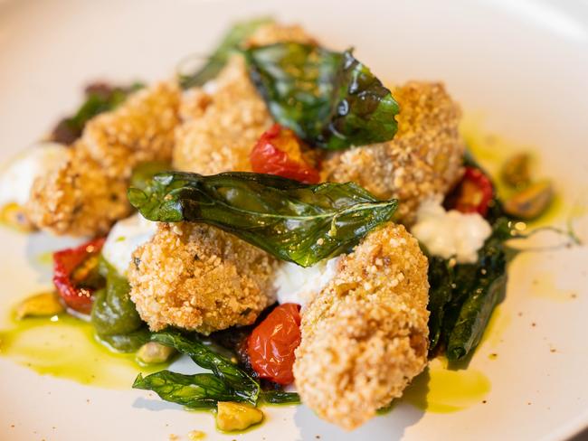 Fried green tomatoes with sugar smoked eggplant, goats cheese and herbs is another of the Waggon’s delicious starter. Picture: Linda Higginson