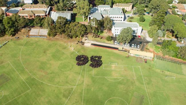 Current Rostrevor College students form a 95 on the school oval, to celebrate the school’s 95th anniversary.