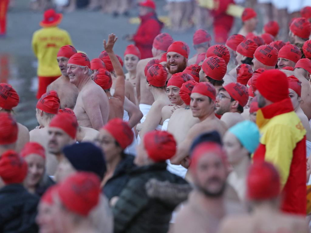 DARK MOFO 2019: Participants of the nude solstice swim brave the cold water at dawn at Long Beach, Sandy Bay. Picture: LUKE BOWDEN