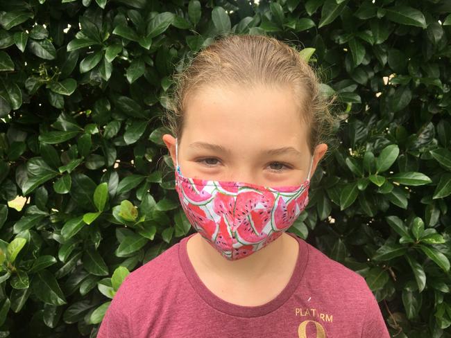 Katerina McGilchrist wears a mask as she encourages people to donate them to the needy. Picture: supplied