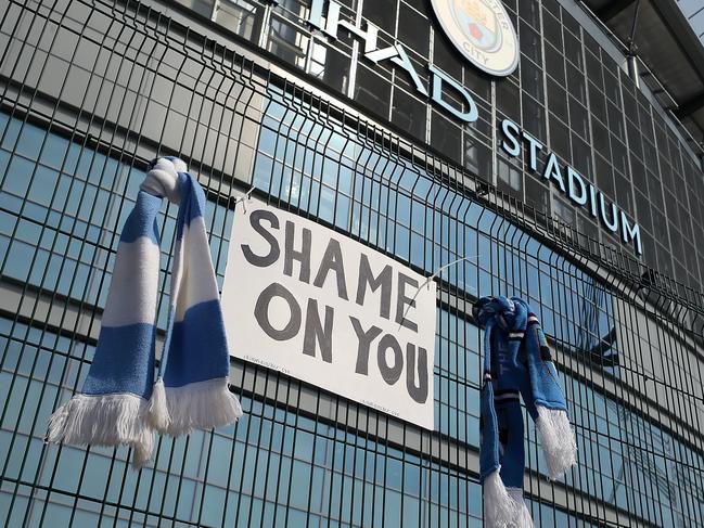 MANCHESTER, ENGLAND - APRIL 20: A sign which reads 'Shame On You' is placed between two Manchester City scarves outside the Etihad Stadium on April 20, 2021 in Manchester, England. Six English premier league teams have announced they are part of plans for a breakaway European Super League. Arsenal, Manchester United, Manchester City, Liverpool, Chelsea and Tottenham Hotspur will join 12 other European teams in a closed league similar to that of the NFL American Football League. In a statement released last night, the new competition 