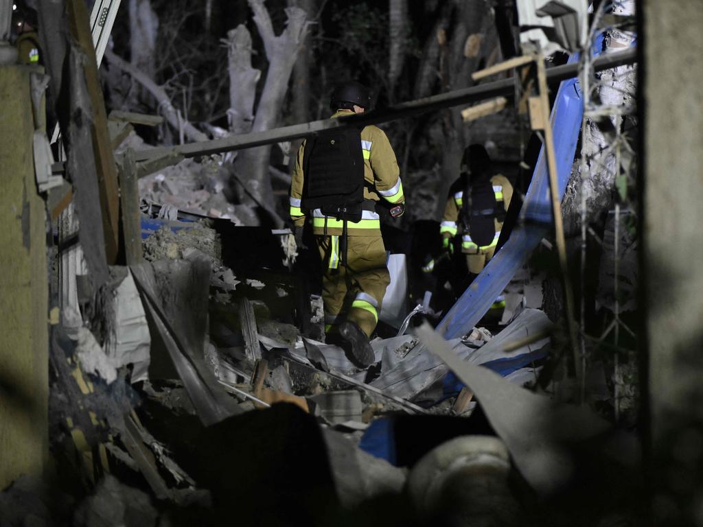 Ukrainian emergency services conduct a search and rescue operation among the rubble of a destroyed hotel.