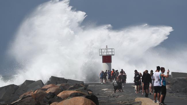 People at The Gold Coast Seaway as Cyclone OMA whips up wild conditions. Picture: Jason O'Brien