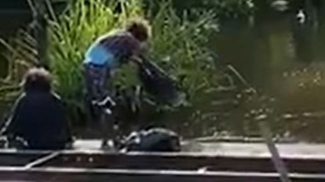 A video has surfaced showing a group of people dumping rubbish into the Howard River in the Northern Territory from the old Iron Bridge, sparking outrage.