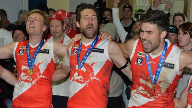 Troy Schwarze celebrates Sorrento’s 2017 premiership with teammates, Aaron Paxton (left) and Chris Dawes (right). Schwarze is making a comeback. Picture: Chris Eastman