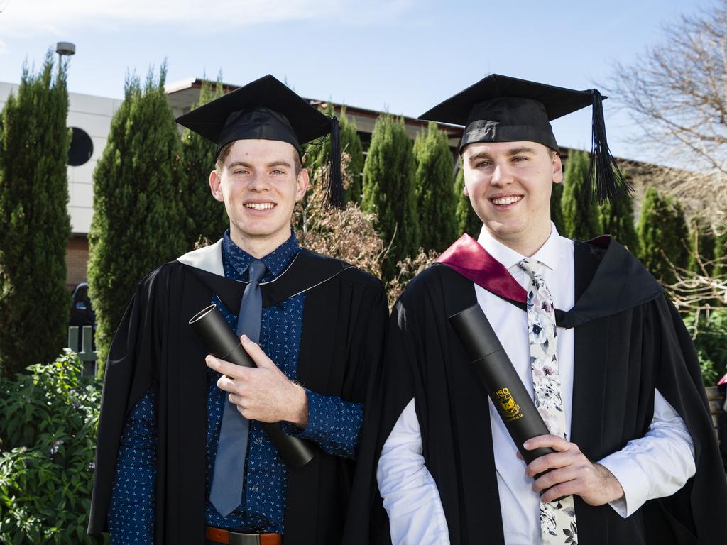 College mates originally from Warwick William Jamieson (left), graduating with a Bachelor of Creative Arts (Music), and Mitch Hay, graduating with a Bachelor of Urban and Regional Planning, at a UniSQ graduation ceremony at Empire Theatres, Wednesday, June 28, 2023. Picture: Kevin Farmer