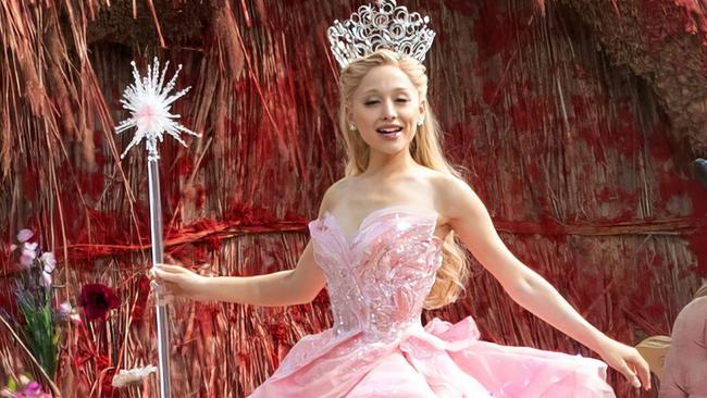 ONE TIME WEB USE FOR NEWS.COM.AU ONLY - FEES APPLY FOR REUSE - CONTACT MEDIA MODE -  EXCLUSIVE: PREMIUM EXCLUSIVE *PRINT FEES TO BE AGREED* Ariana Grande has been spotted in costume for the FIRST TIME on the set of her much-anticipated new movie Wicked, in which she plays Glinda the Good Witch.The singer was spotted wearing a sparkling pink princess dress and a dazzling tiara as she filmed the OPENING SCENE in Buckinghamshire today (Mon).Ariana, 29, was seen holding a wand and had her long blonde locks flowing as she landed in the fantastical Land of Oz on a large gold throne.She was greeted by the citizens of Oz, celebrating the death of the Wicked Witch of the West, who has been killed by Dorothy.They clapped and cheered as she arrived, then were seen dancing in the streets of the magical Land of Oz, which has been built on farmland in the village of Ivinghoe, near Leighton Buzzard.Ariana was then seen walking down steps into the crowd as they all launched into the song, No One Mourns the Wicked.Wicked, which is mostly set before DorothyÃÂ¢Ãâ¬Ãâ¢s arrival in Oz, tells the story from the perspective of the witches, Elphaba, the Wicked Witch of the West and Glinda, the Good Witch.Ariana stars opposite Cynthia Erivo, who plays Elphaba in the two-part adaptation, with filming set to continue until August.The Land of Oz, a stunning town of tiny cottages with colourful thatched roofs has been created in fields in Buckinghamshire for the Universal Pictures production.A large poster saying: ÃÂ¢Ãâ¬ÃÅBeware the Wicked WitchÃÂ¢Ãâ¬ÃÂ could be seen today (Mon) on the wall of one of the cottages.The magnificent Emerald city, capital of the Land of Oz, is also taking shape in an adjacent field, with the green domed roofs already in place.Wicked is based on Gregory Maguire's 1995 novel of the same name and was first performed on Broadway in 2003 before opening at the Apollo Theatre in London three years later.Stephen Schwartz and Winnie Holzman, who co-wrote the music and lyrics to the Broadway show, have adapted the screenplay while Jon M Chu is directing.