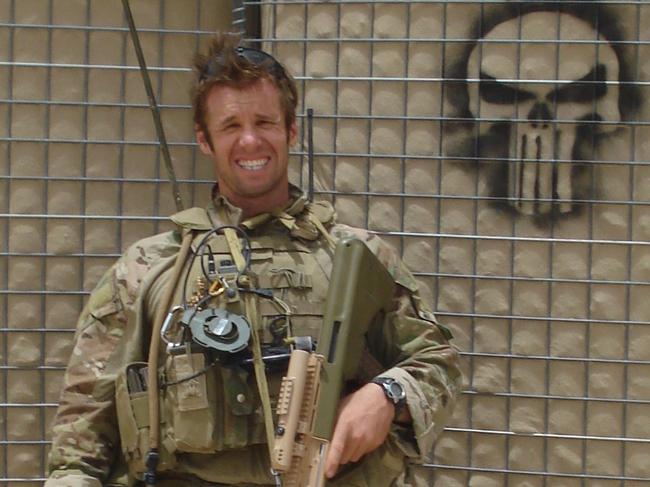 Sergeant Justin Huggett with a Punisher symbol in Afghanistan in 2011.