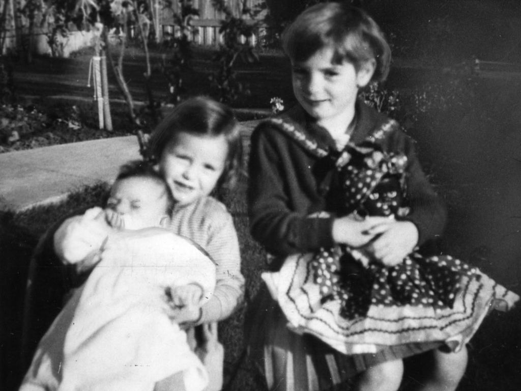 <p>Arnna proudly holds her baby brother, Grant, while Jane watches on.</p>