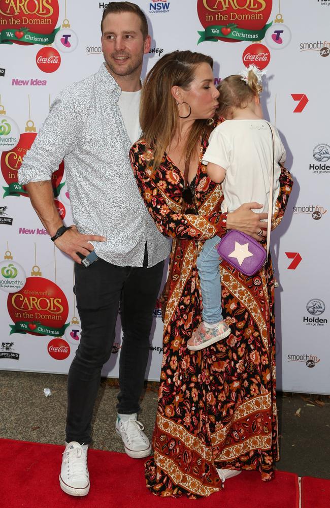 Kate comforts her camera-shy daughter.