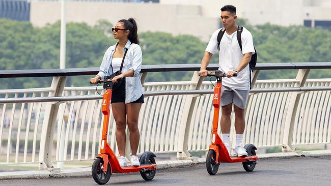 Boom times: E-scooter travellers in Brisbane. Picture: AAP Image/Richard Walker