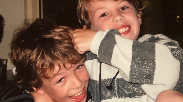 Callum and Tyler Brown rough-house at home as kids.