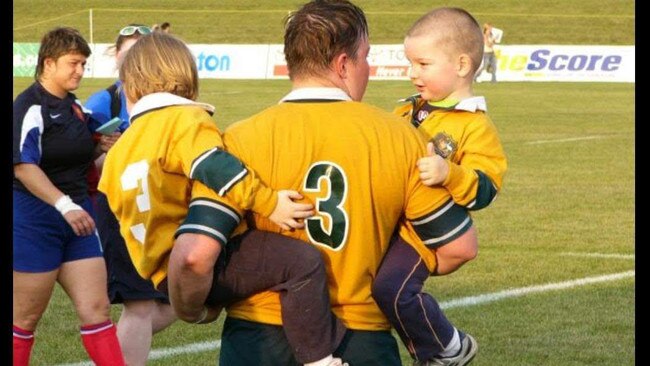 Vanessa Bradley with her two children after playing for Australia.