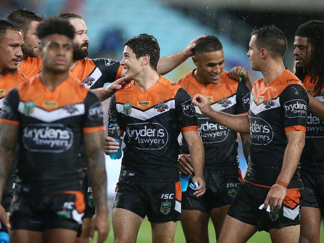 Mitch Moses celebrates with teammates after their victory in the round one NRL match between the South Sydney Rabbitohs and the Wests Tigers at ANZ Stadium. Picture: Getty Images