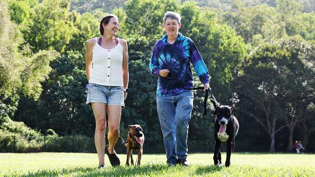 RAA foster carers Azura van Vliet and Liz Ferris taking their RAA foster dogs Sparky and Lucy for a walk at the Aeroglen dog park. Picture: Brendan Radke