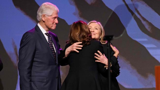 Kamala Harris hugs former Secretary of State Hillary Clinton at the funeral of US Representative Sheila Jackson Lee as Bill Clinton looks on. Picture: AFP.