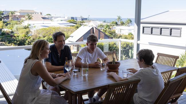 Blue skies: Sarah Tebbutt and Sergio Zaccaria on the deck of their Manly home with Oliver and Sebastian. Picture: David Kelly