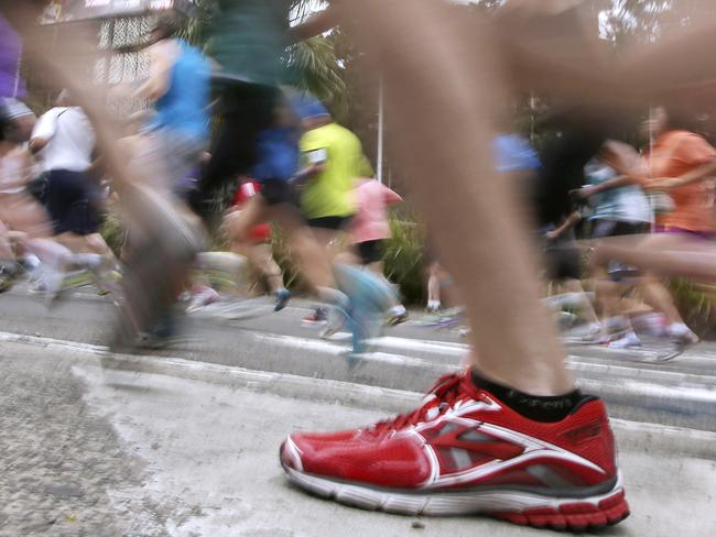 Some of the more than 80,000 registered runners race up Williams Street in Sydney, Sunday, Aug. 10, 2014, at the start of the City 2 Surf annual fun run. Competitors are running the 14 km (8.7 mile) course raising millions of dollars for charities. (AP Photo/Rick Rycroft)