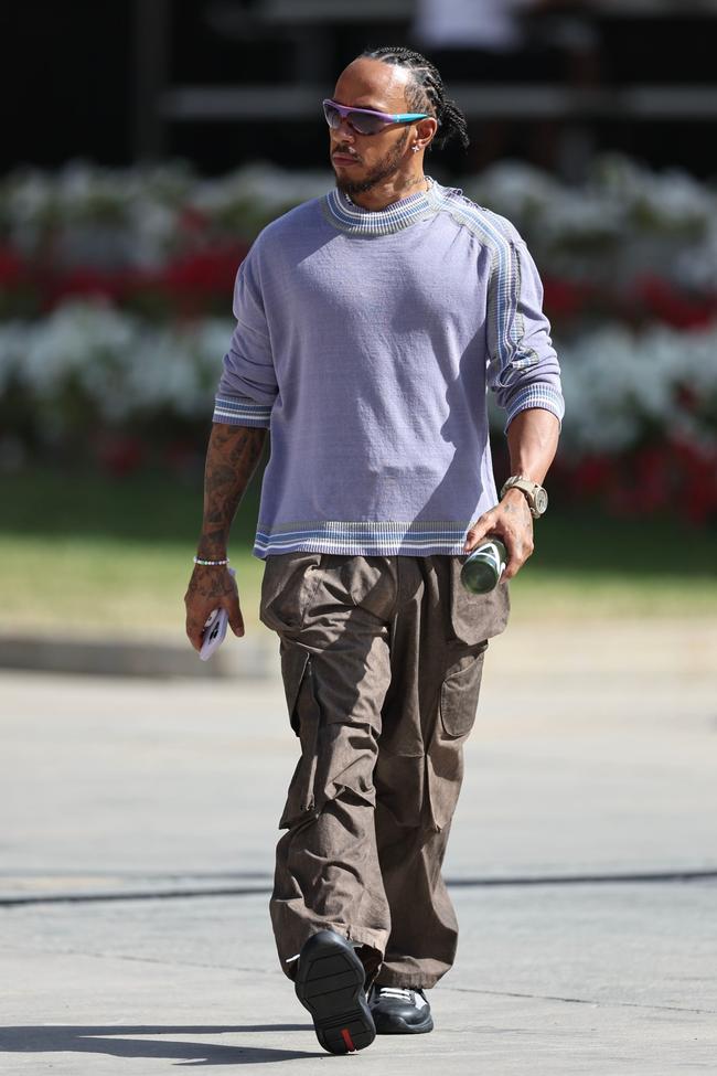 Lewis Hamilton wears a Kiko Kostadinov sweater, Entire Studios cargo pants, Louis Vuitton sunglasses, Prada sneakers and Tiffany & Co. earrings ahead of the Bahrain Grand Prix.