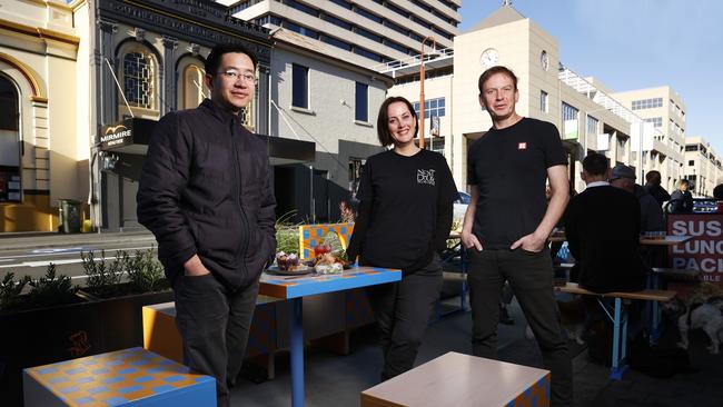 Ho Nguyen of UnPhogettable, Lisa Monro (Monro) of Next Door Coffee, David Painter of Sush with one of the new outdoor dining areas installed in Collins Street. Launch of Transforming Collins Street by City of Hobart. Picture: Nikki Davis-Jones